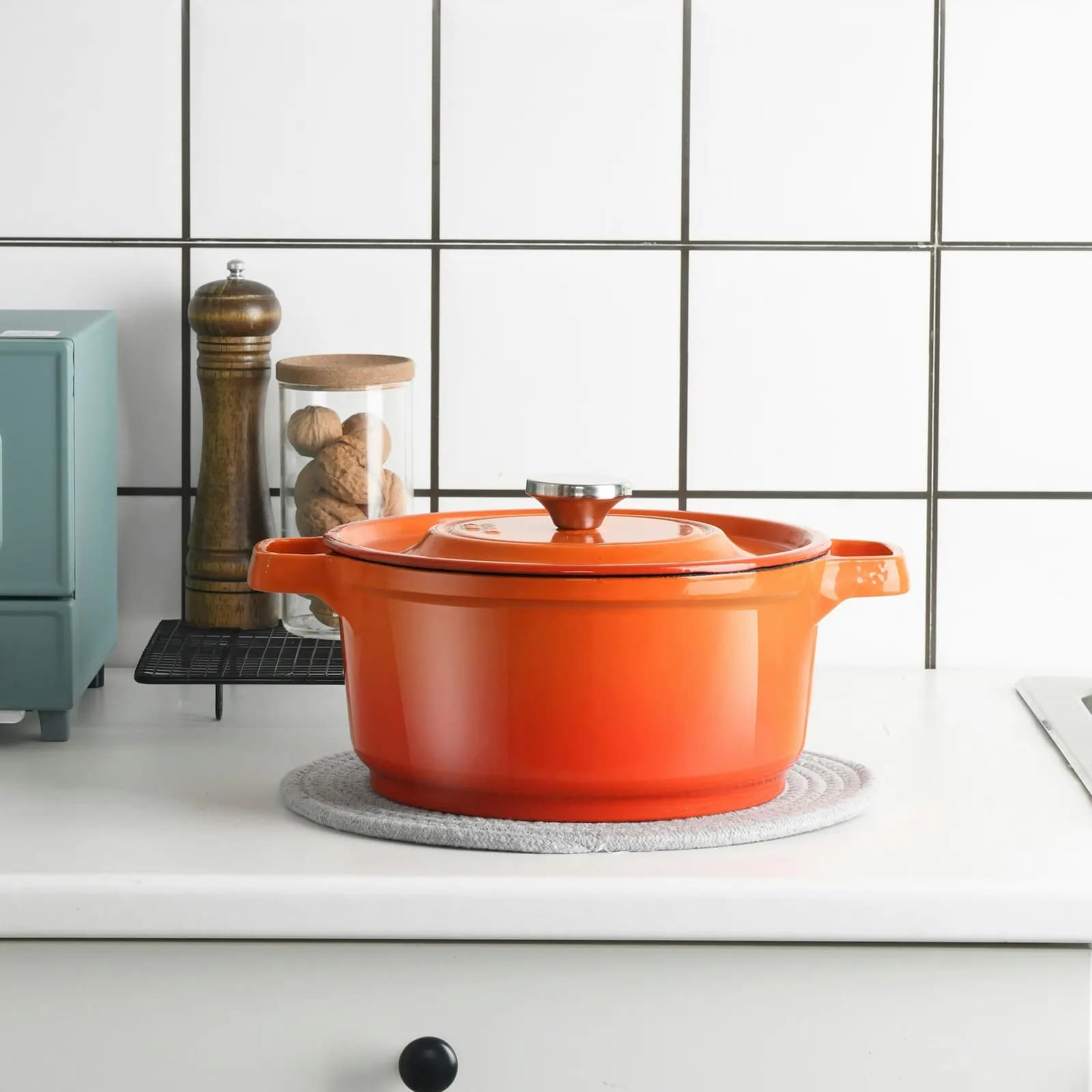 An orange casserole pot on a kitchen counter