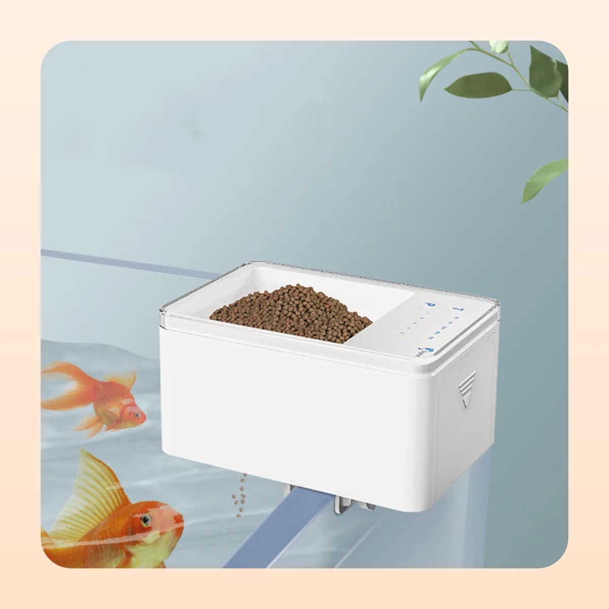 The Kindral digital feeder hooked over a tank rim above goldfish