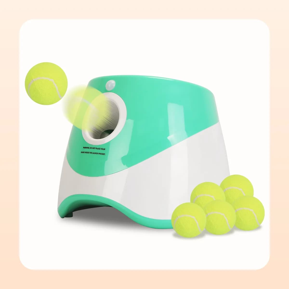 Kindral automatic dog ball launcher in mint green and white with six tennis balls