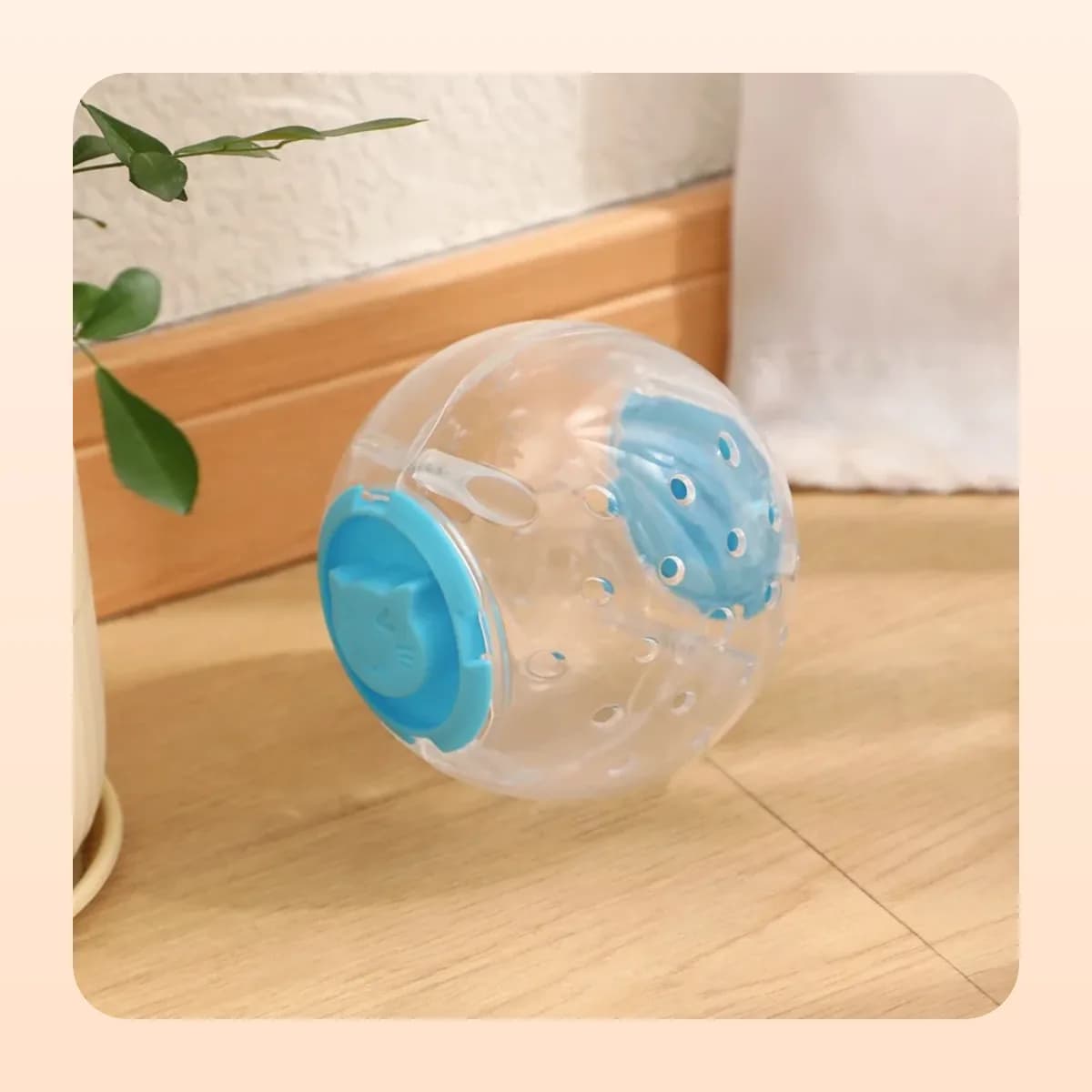 Kindral treat-dispensing ball with a blue lid