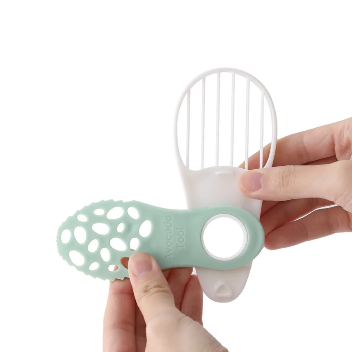 Kindral avocado slicer in mint green and white, opened out
