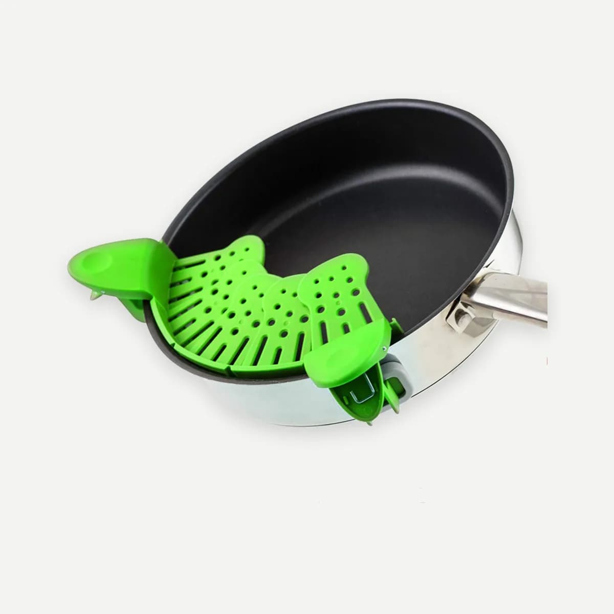 Kindral clip-on pot strainer in green, clipped to a pan