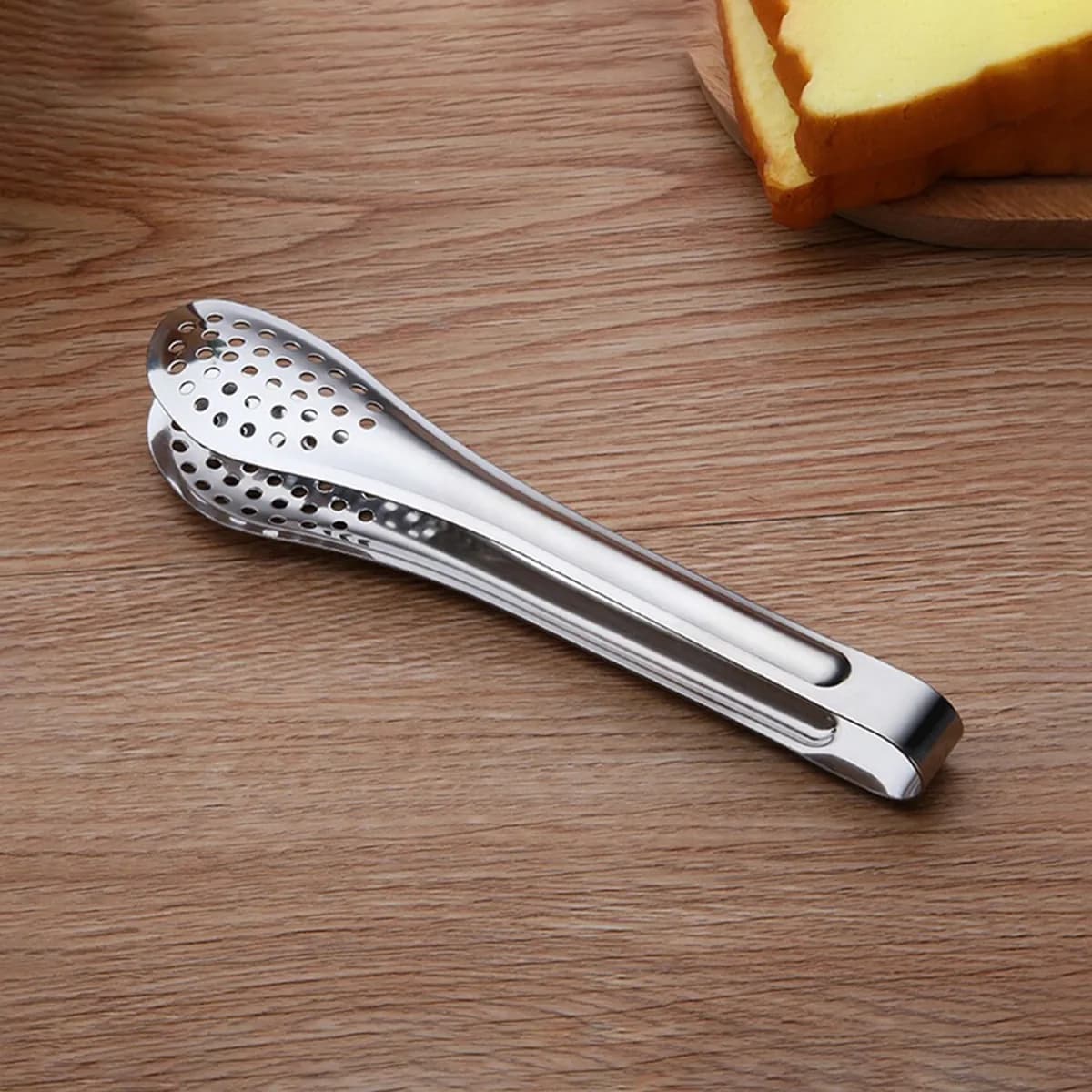 Kindral slotted pickle tongs in stainless steel