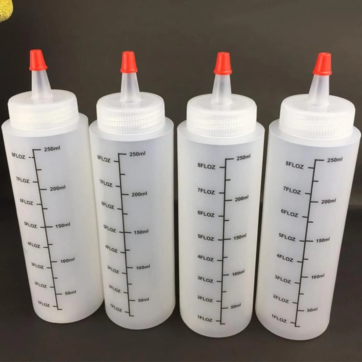 Kindral squeeze bottles in clear white with red caps