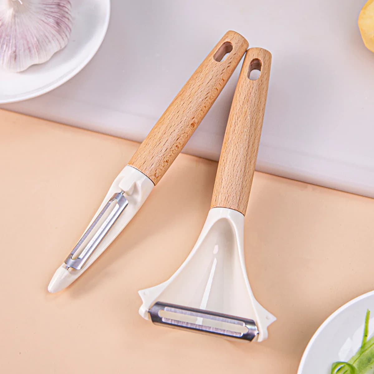 Kindral Y peeler and straight peeler with beech handles on a worktop